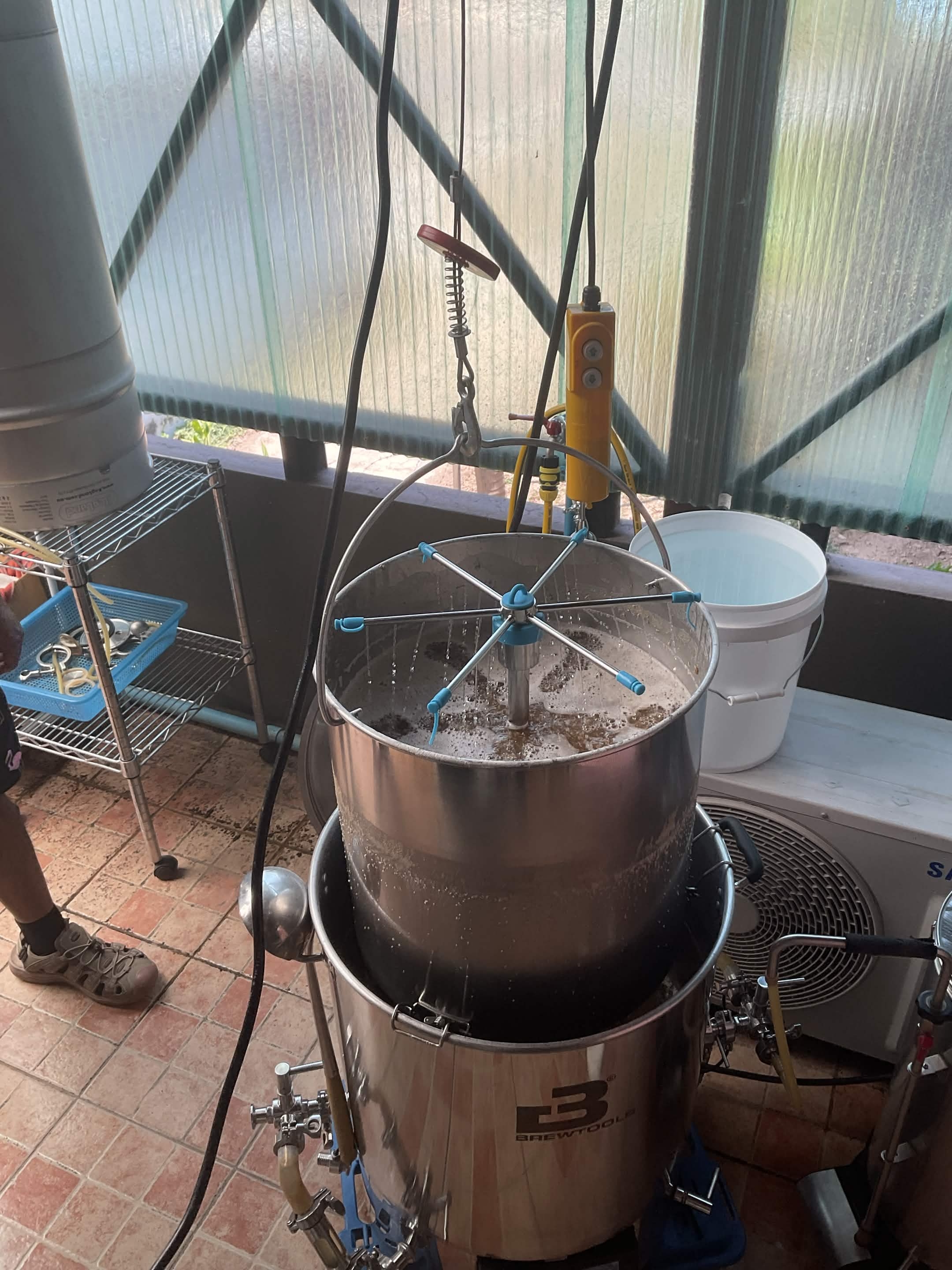 Brewtools B80 with grain basket hoisted — SAMSUNG AC unit visible right (compressor zone)